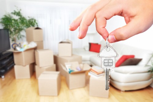 Local movers handling desks and storage units during a Northwood business move