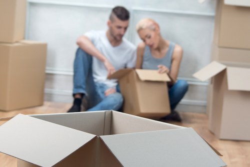 Local packing team preparing fragile household items in Northwood
