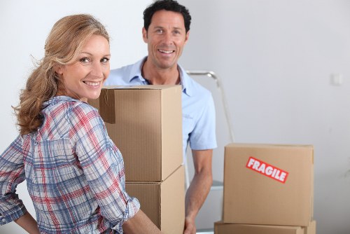 Moving team handling boxes and furniture at a Northwood property